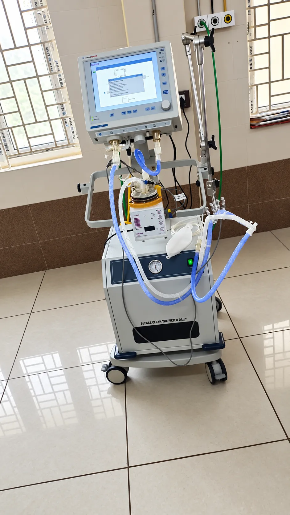 Ventilator unit positioned in a hospital room